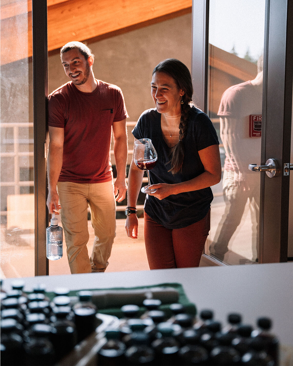 Penner-Ash team sharing a laugh in the doorway of the winery.